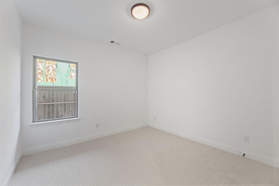 Empty room with carpet and baseboards Empty room with carpet and baseboards