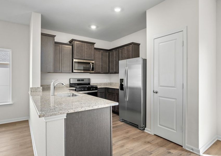 The kitchen of the Primrose has sprawling granite countertops.