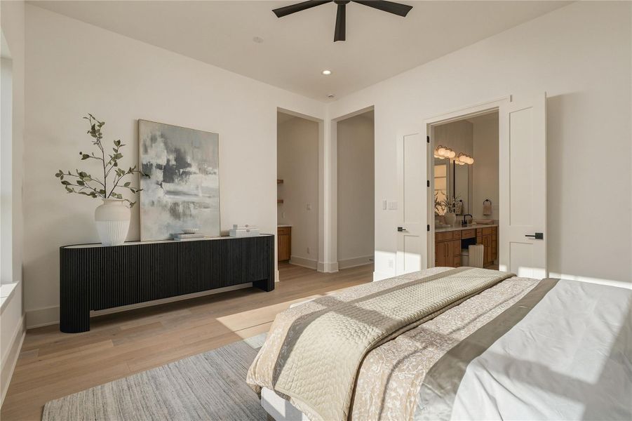 A second perspective of the primary suite reveals its private connection to the ensuite bath and dual custom closets, creating a retreat designed with both comfort and function in mind.
