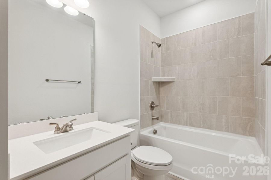 2nd floor hall bath with tile walls