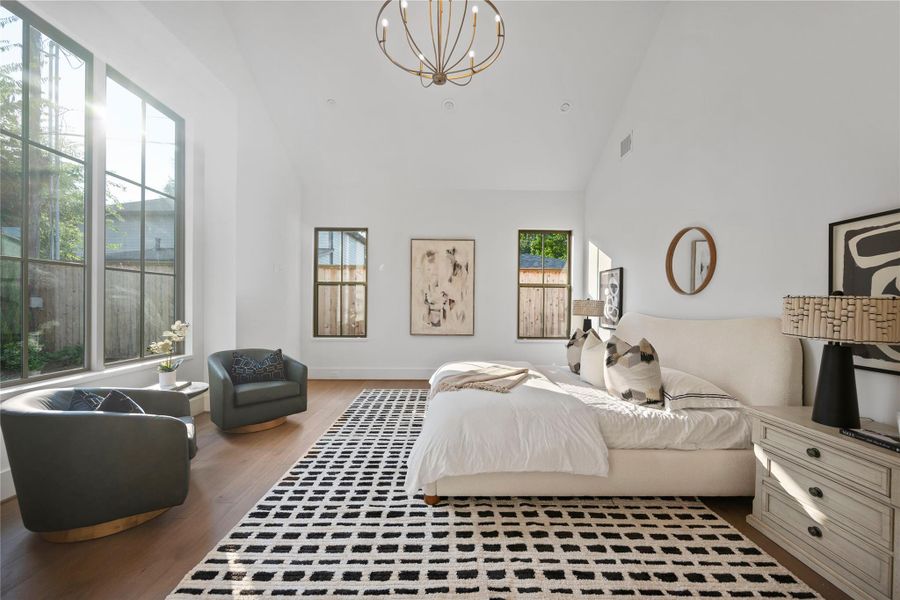 Bright and inviting primary suite featuring high ceilings with exposed wooden beams. Bright and inviting primary suite featuring high ceilings with exposed wooden beams.