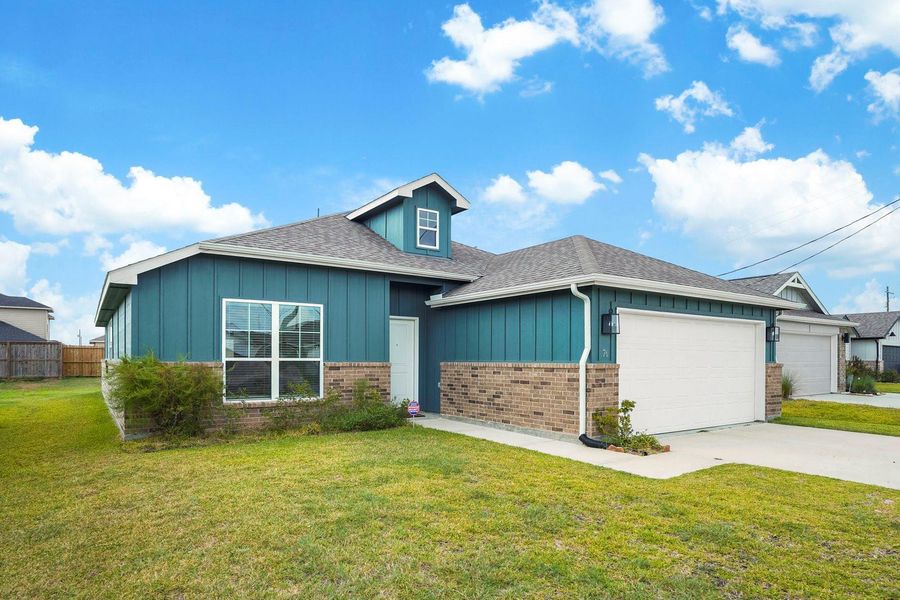 Front exterior of a new home in Santa Fe, Cleveland, TX, highlighting curb appeal (Image 2).