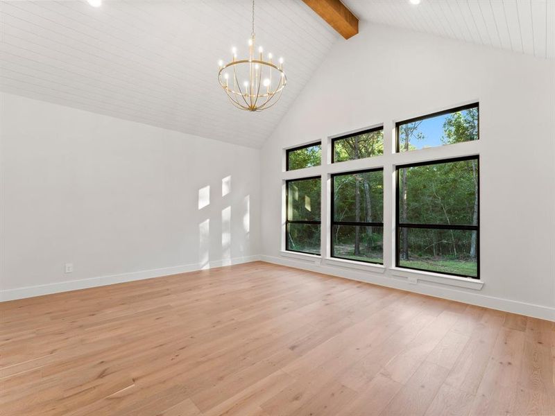 Primary Bedroom with Vaulted Shiplap Ceiling and Highlighted with Wood Beam