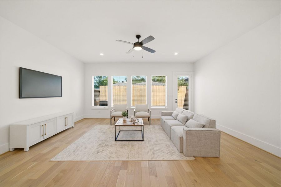 Light-filled living room featuringgenerous proportions, designerfinishes, and walls of windowscreating an airy feel. (Photo of a previous build, similar finishes.)