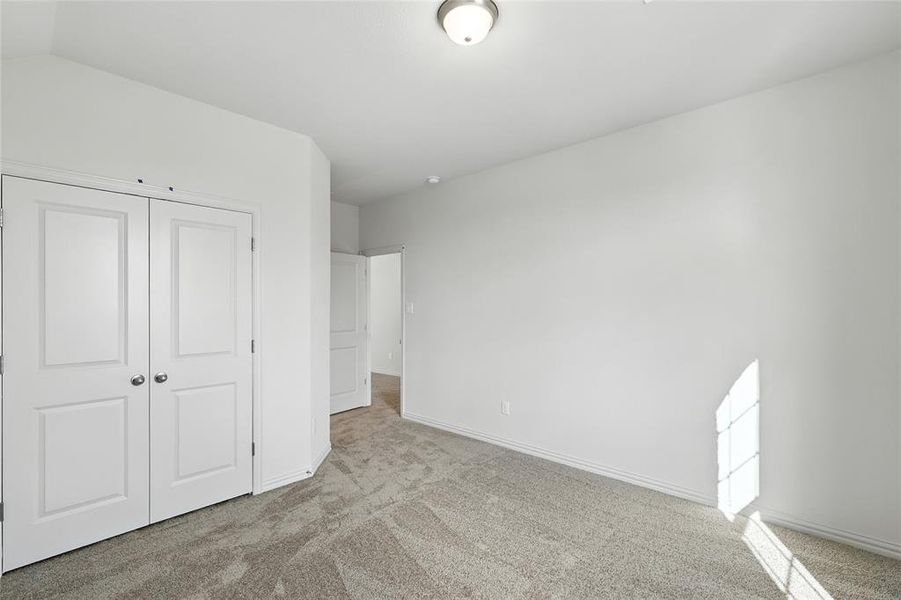 Unfurnished bedroom featuring carpet floors and a closet