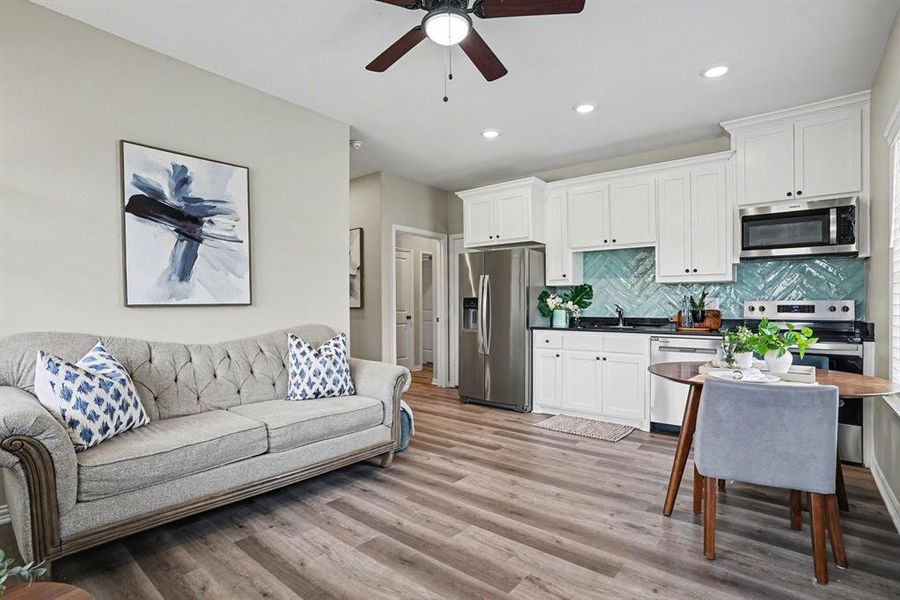 Living area with ceiling fan, kitchette, eat in kitchen, light wood-style flooring, and recessed lighting
