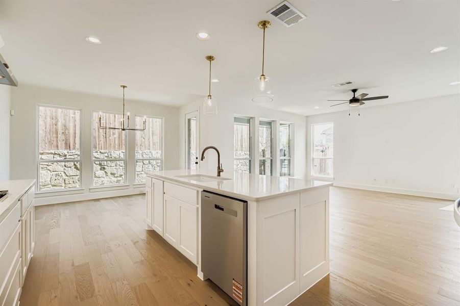 Kitchen featuring stainless steel dishwasher, light wood finished floors, a ceiling fan, recessed lighting, and light countertops