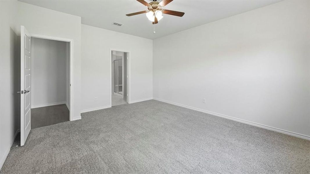 Unfurnished bedroom featuring carpet floors and ceiling fan