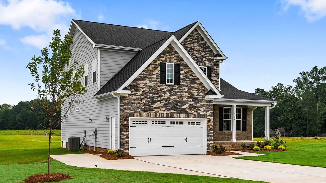 Front exterior of a new home in Lilah Grove, Summerfield, NC, highlighting curb appeal (Image 25).