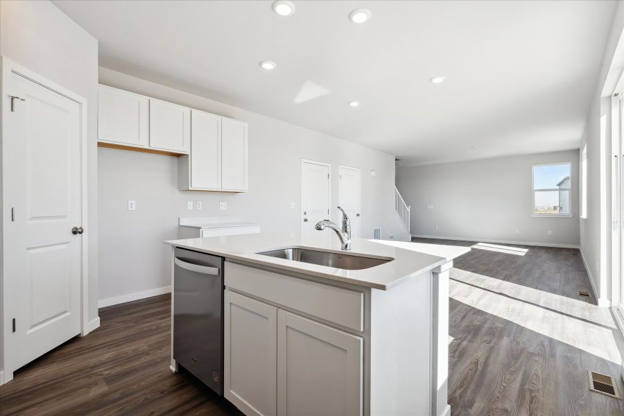 A kitchen with white cabinets.