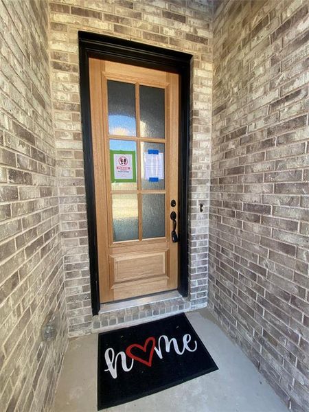 Welcoming front entry with impressive 8 ft iron & glass front door (not stained yet.)