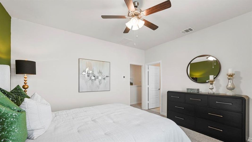 Bedroom featuring carpet floors and ceiling fan Bedroom featuring carpet floors and ceiling fan