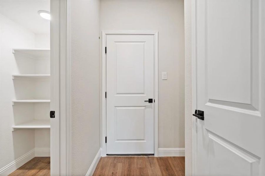 Corridor featuring hardwood / wood-style flooring