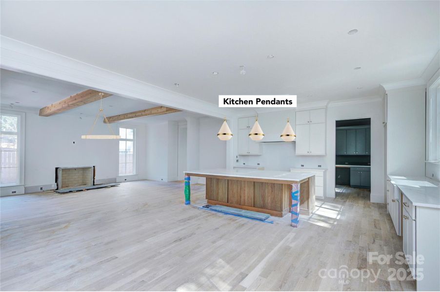 Kitchen with view of scullery and living area with wood burning fireplace. Kitchen with view of scullery and living area with wood burning fireplace.