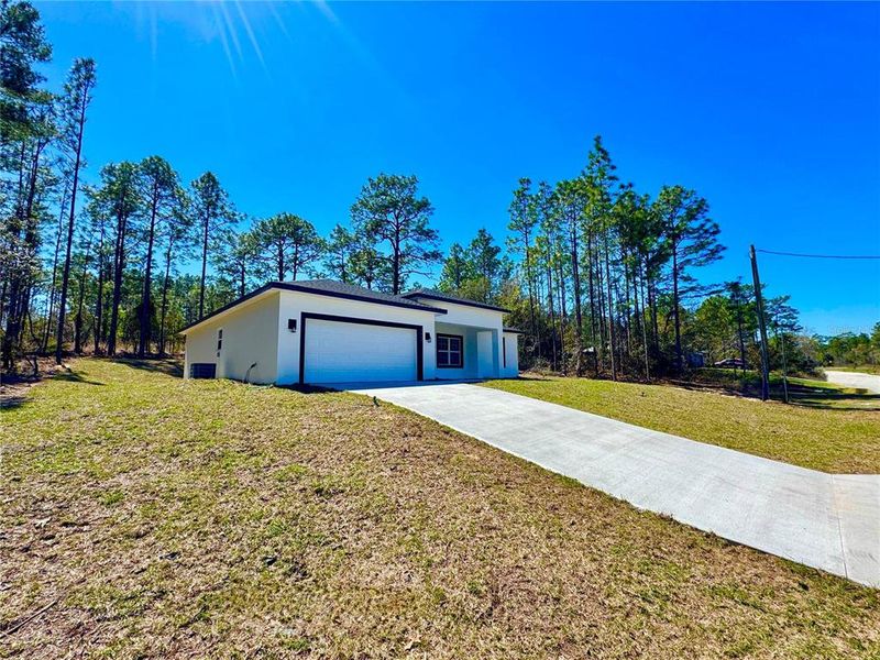 Front exterior of a new home in , Citrus Springs, FL, highlighting curb appeal (Image 2).