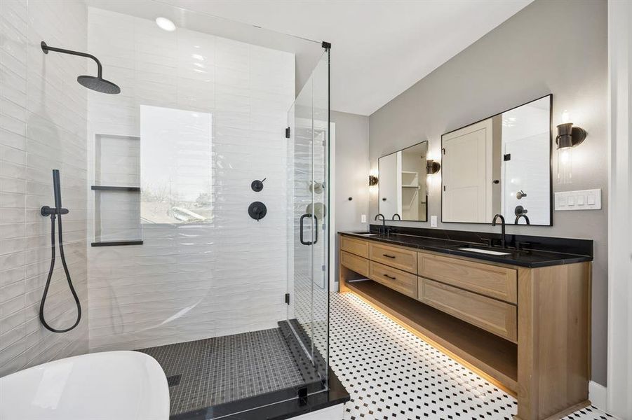 Bathroom with double vanity, a shower stall, and a freestanding tub Bathroom with double vanity, a shower stall, and a freestanding tub