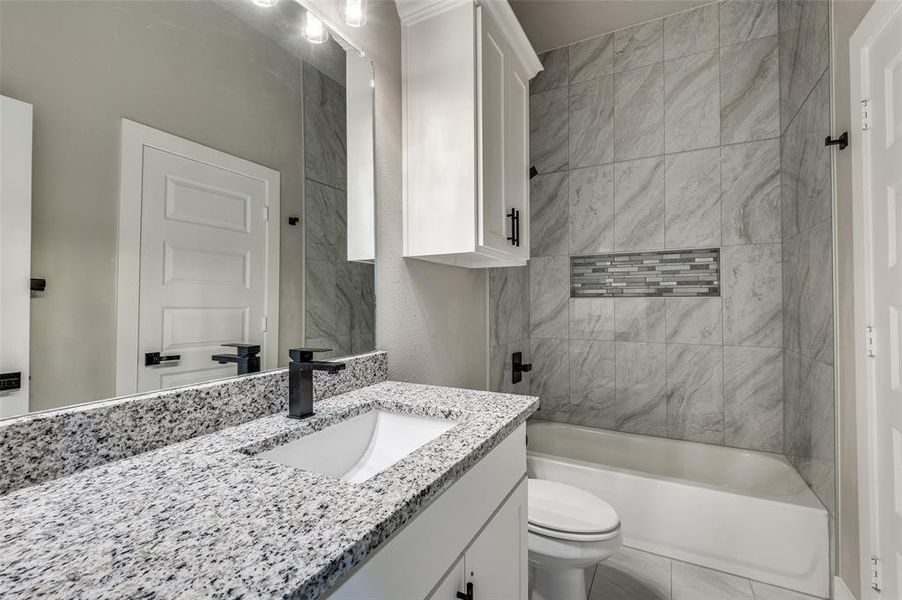Bathroom featuring vanity and shower / tub combination Bathroom featuring vanity and shower / tub combination