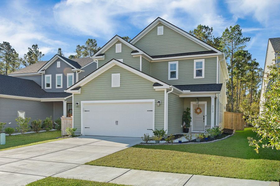 Front exterior of a new home in Jasmine Point at Lakes of Cane Bay, Summerville, SC, highlighting curb appeal (Image 1).