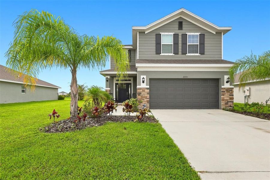 Front exterior of a new home in Aviary at Rutland Ranch, Parrish, FL, highlighting curb appeal (Image 1). Front exterior of a new home in Aviary at Rutland Ranch, Parrish, FL, highlighting curb appeal (Image 1).