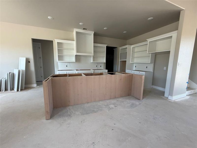 Kitchen featuring unfinished concrete floors and a center island