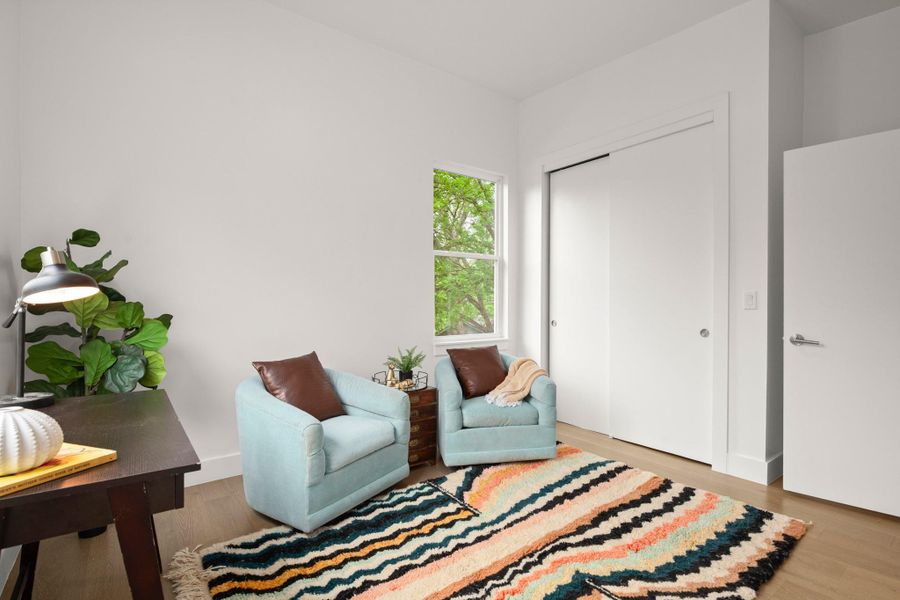 Light wood-finish flooring complements the neutral wall color