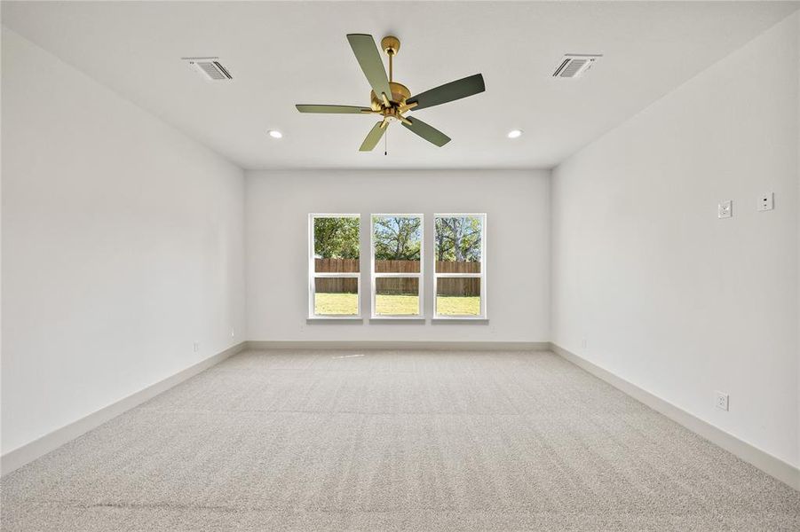 Carpeted empty room featuring recessed lighting and ceiling fan