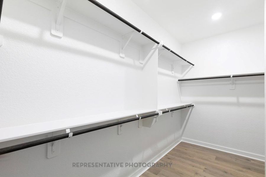 Walk in closet featuring wood finished floors Walk in closet featuring wood finished floors