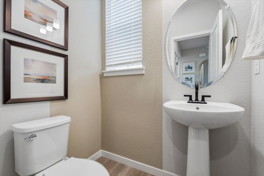 A bathroom with a sink and a mirror. A bathroom with a sink and a mirror.