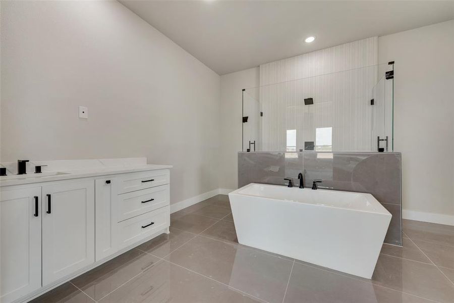 Bathroom with plus walk in shower, tile patterned floors, and vanity