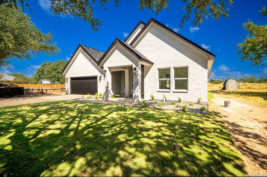 Front exterior of a new home in , La Vernia, TX, highlighting curb appeal (Image 16).