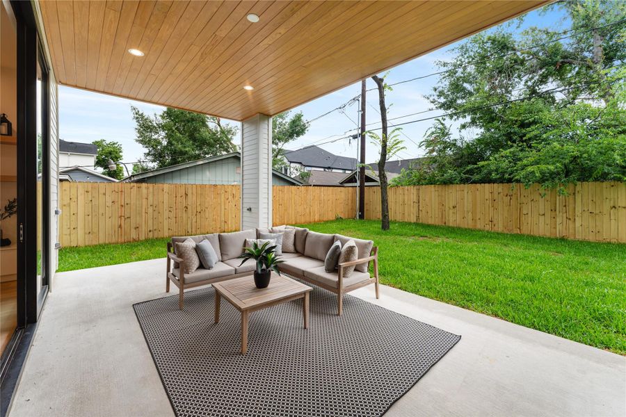 Generous covered patio provides the perfect foundation for outdoor living (when the Houston weather is just right), thoughtfully pre-plumbed for a full outdoor kitchen installation.