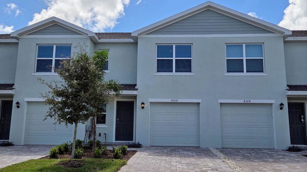 Front exterior of a new home in Creekside, Fort Pierce, FL, highlighting curb appeal (Image 1). Front exterior of a new home in Creekside, Fort Pierce, FL, highlighting curb appeal (Image 1).