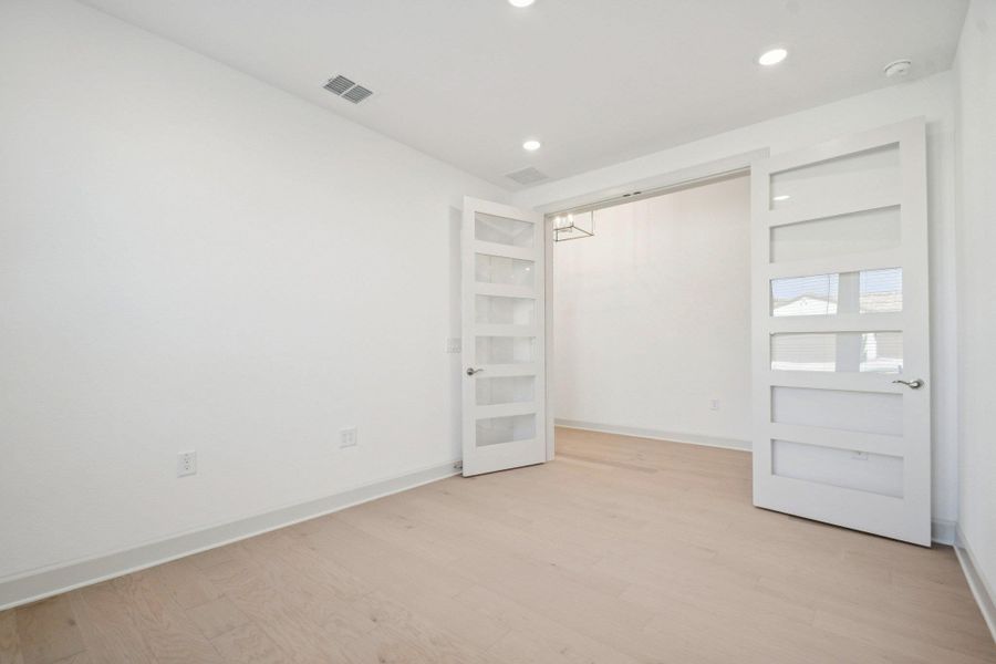 Empty room featuring light wood-type flooring and recessed lighting Empty room featuring light wood-type flooring and recessed lighting