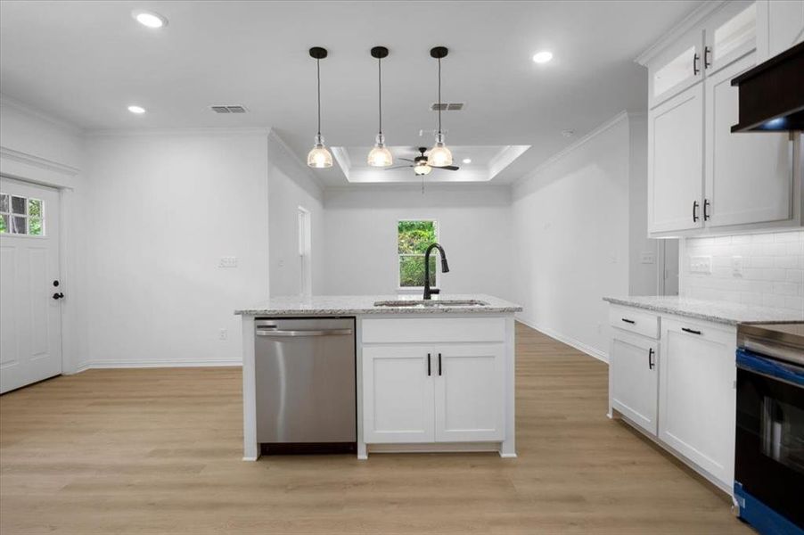 Kitchen with white cabinetry, hanging light fixtures, stainless steel dishwasher, light stone counters, and electric range oven