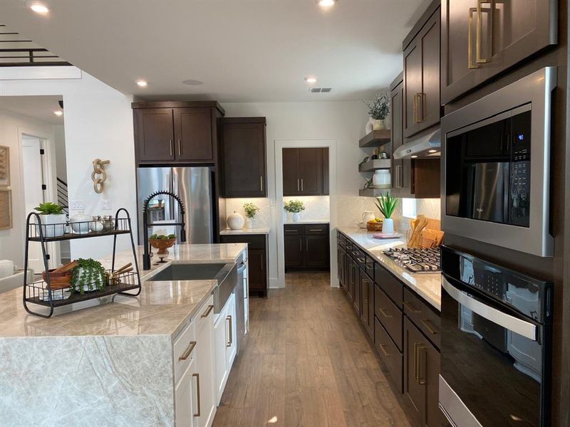 Built-in stainless steel appliances. Pot and pan drawers under cooktop.