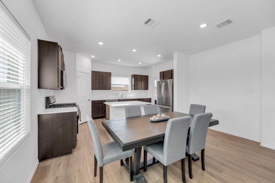 Dining area featuring recessed lighting, light wood-style floors, baseboards, and visible vents