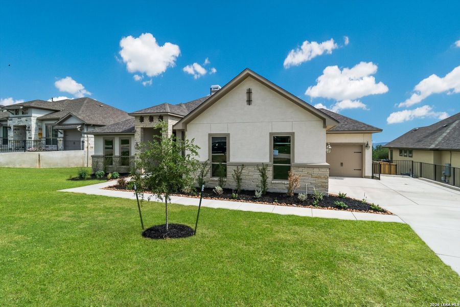 Front exterior of a new home in Johnson Ranch, Bulverde, TX, highlighting curb appeal (Image 21). Front exterior of a new home in Johnson Ranch, Bulverde, TX, highlighting curb appeal (Image 21).