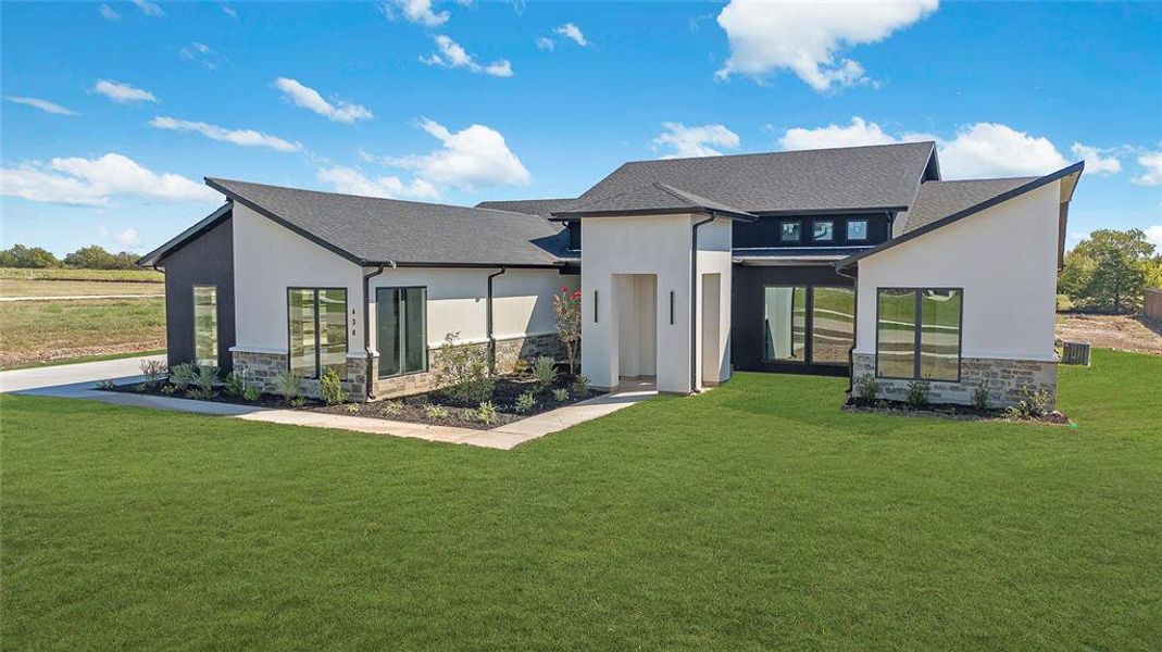 Contemporary exterior featuring a black and white facade with stone accents Contemporary exterior featuring a black and white facade with stone accents