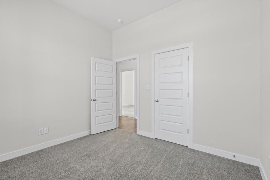 Unfurnished bedroom featuring carpet floors and a closet