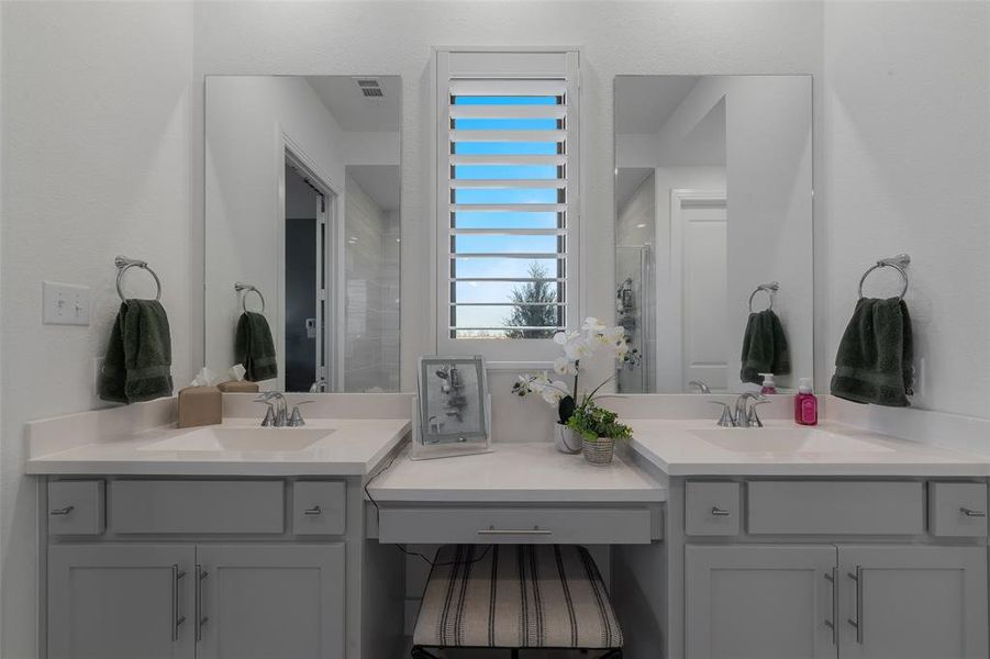 Bathroom featuring two vanities, a sink, and visible vents