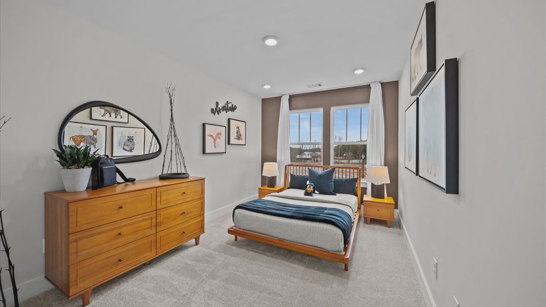 Superior comfort in a secondary bedroom with plush carpet and an oversized walk-in closet