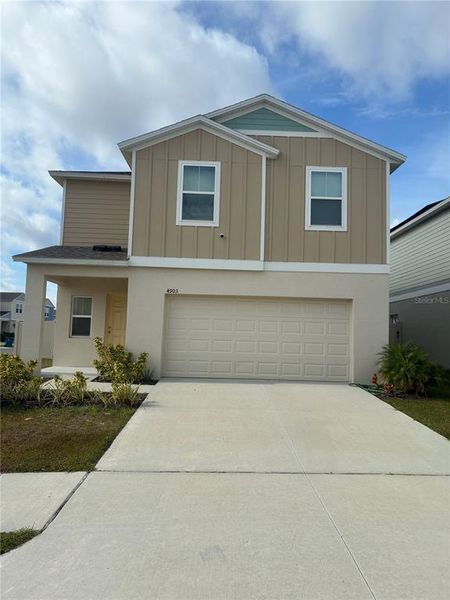 Front exterior of a new home in Hammock Reserve, Haines City, FL, highlighting curb appeal (Image 23).