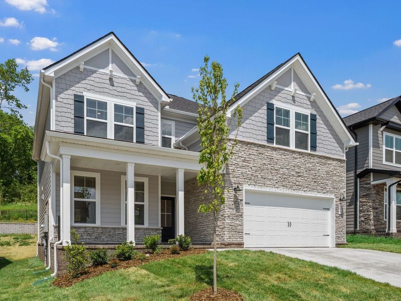 Front exterior of a new home in Woods Crossing, Gallatin, TN, highlighting curb appeal (Image 2). Front exterior of a new home in Woods Crossing, Gallatin, TN, highlighting curb appeal (Image 2).