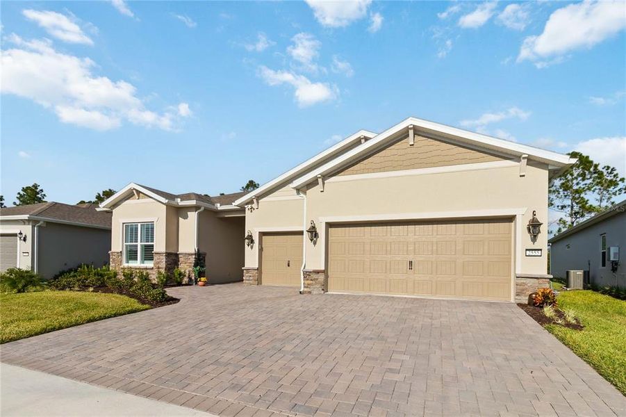 Front exterior of a new home in Del Webb Sunbridge, St. Cloud, FL, highlighting curb appeal (Image 2).