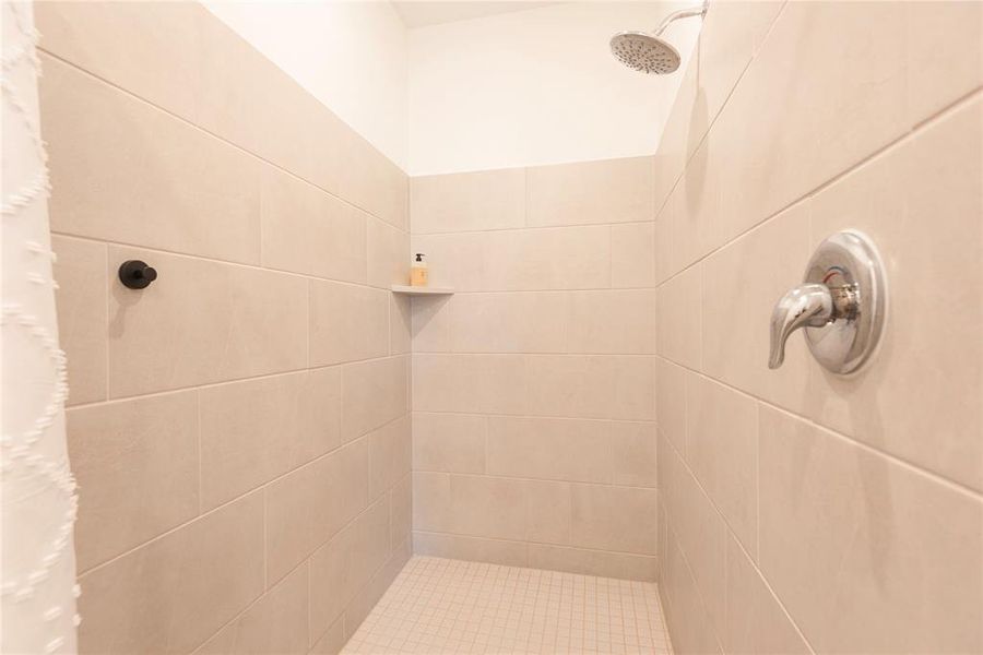 Bathroom featuring a tile shower Bathroom featuring a tile shower