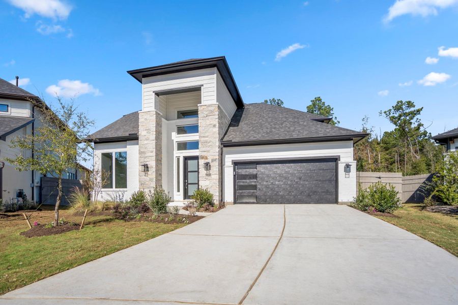 Front exterior of a new home in Artavia, Conroe, TX, highlighting curb appeal (Image 1). Front exterior of a new home in Artavia, Conroe, TX, highlighting curb appeal (Image 1).