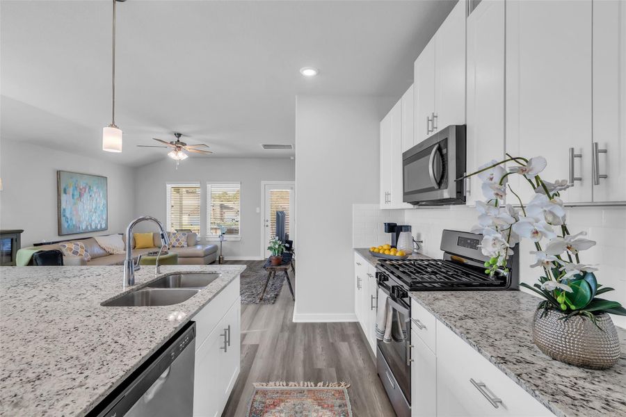 Bright white cabinets and a gas stove.