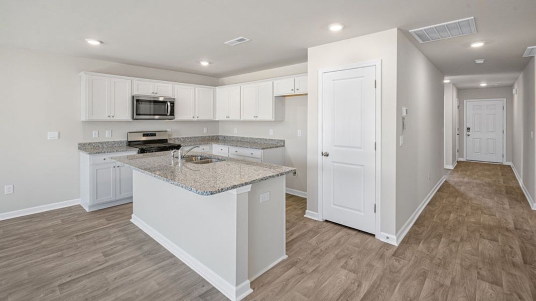 Representative furnished interior of a home built from the FREEPORT by D.R. Horton in River's Edge, Mayodan (Image 4).