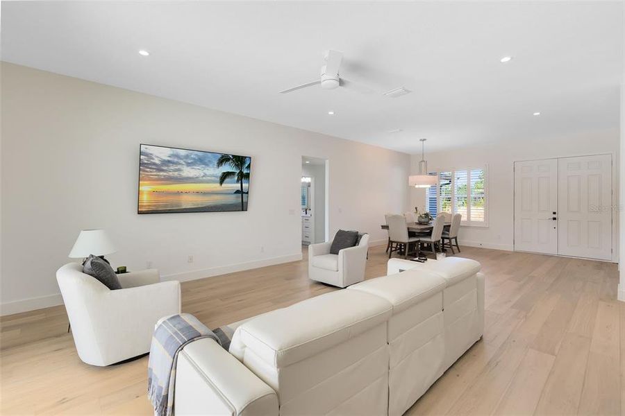 A view from the living room into the dining room and to the double front entry.