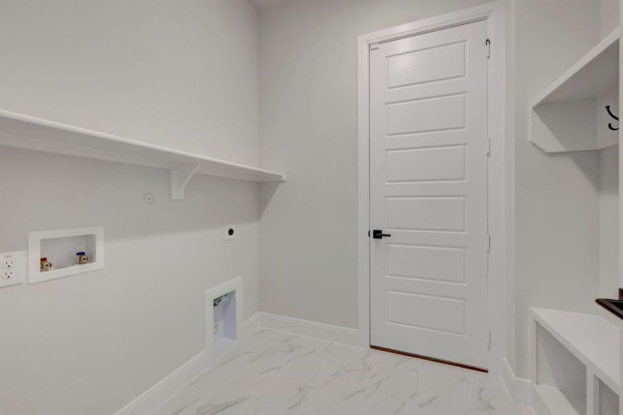 Laundry area featuring light marble finish floors, hookup for a washing machine, and hookup for an electric dryer